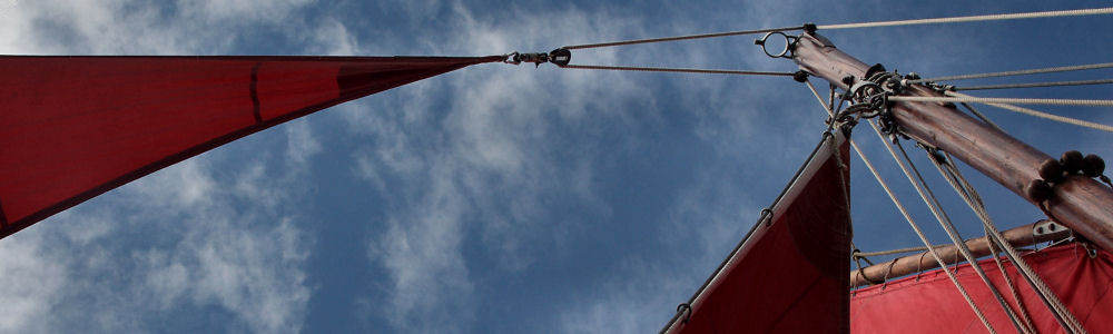 Tan sails and a former telegraph pole